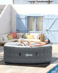 Woman Relaxing In An Inflatable Hot Tub Spa For 4-6 Persons, Square And Grey