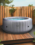 Wave Spa Hot Tub On Deck With Wooden Fence, Featuring The Insulated Hot Tub Mat