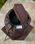 A Brown Hat On a Stone Floor With An Insulated Pump Cover For Egg Pump