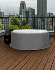 Circular White Intex Purespa Bubble Hot Tub On Wooden Deck With An Insulated Jacket