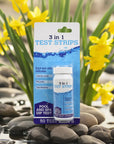 Bottle Of 3 In 1 Pool And Spa Dip Test Strips Next To Rocks For Hot Tub Water Quality