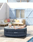 A Woman Relaxing In An Inflatable Hot Tub Bubble Spa For 4 People, Dark Blue Round