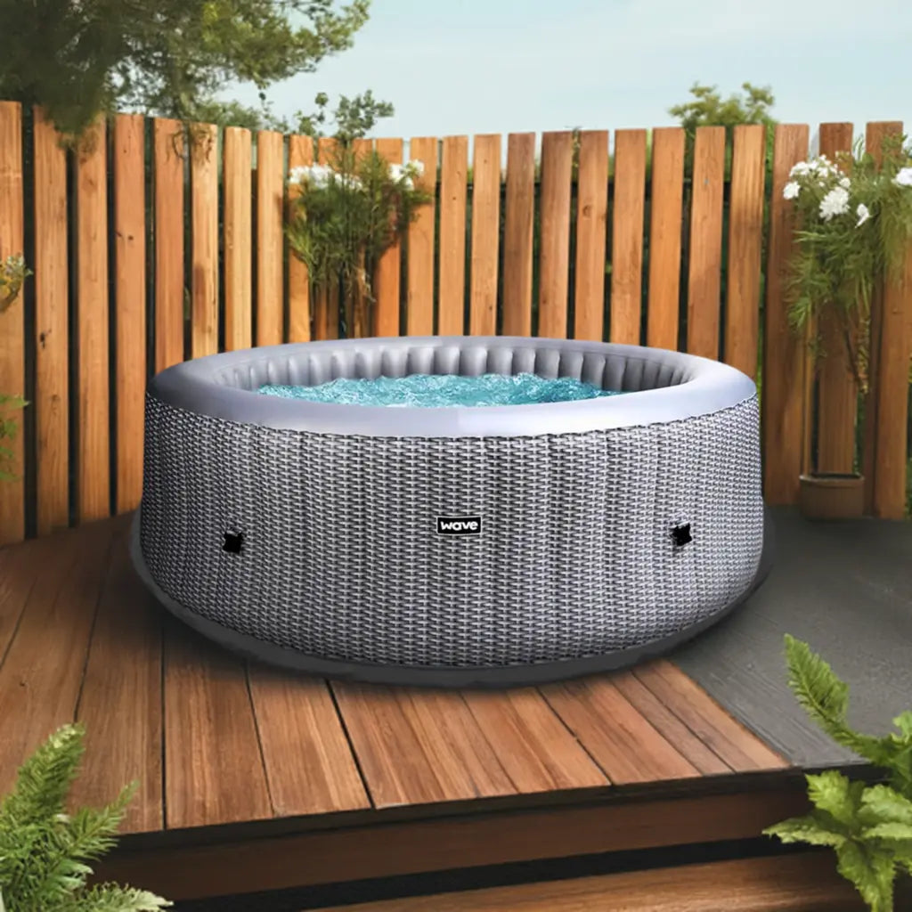 Wave Spa Hot Tub On Deck With Wooden Fence, Featuring The Insulated Hot Tub Mat