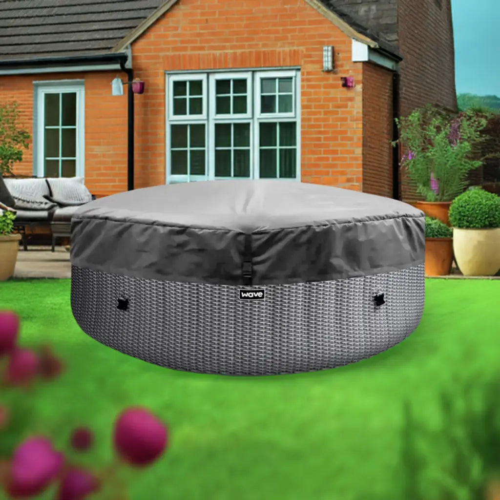 Grey Round Patio Table Cover For Wave Spa Atlantic Hot Tubs On a Green Lawn