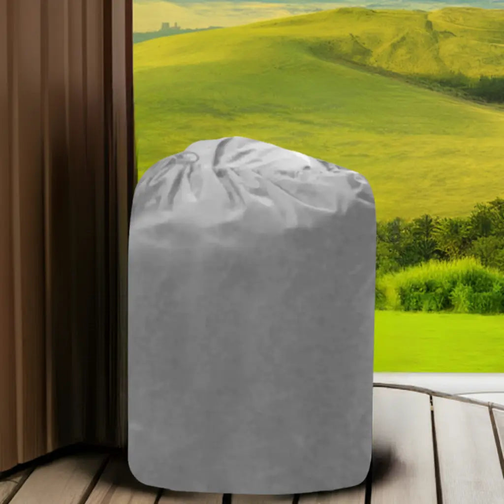 An Insulated Pump Cover For Egg Pump, Depicted By a Grey Trash Bag On a Wooden Floor