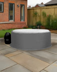 Inflatable Hot Tub With Gray Cover And Insulated Jacket On Patio By Canadian Spa