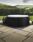 Inflatable Black Hot Tub By Canadian Spa With Insulated Hot Tub Jacket On Stone Patio