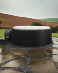 Person Round Inflatable Hot Tub With White Top And Black Sides On Stone Patio