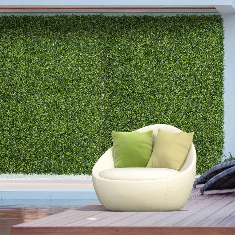 Living Room With Green Artificial Boxwood Wall And White Chair. Realistic Milan Grass Panels