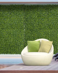 Living Room With Green Artificial Boxwood Wall And White Chair. Realistic Milan Grass Panels